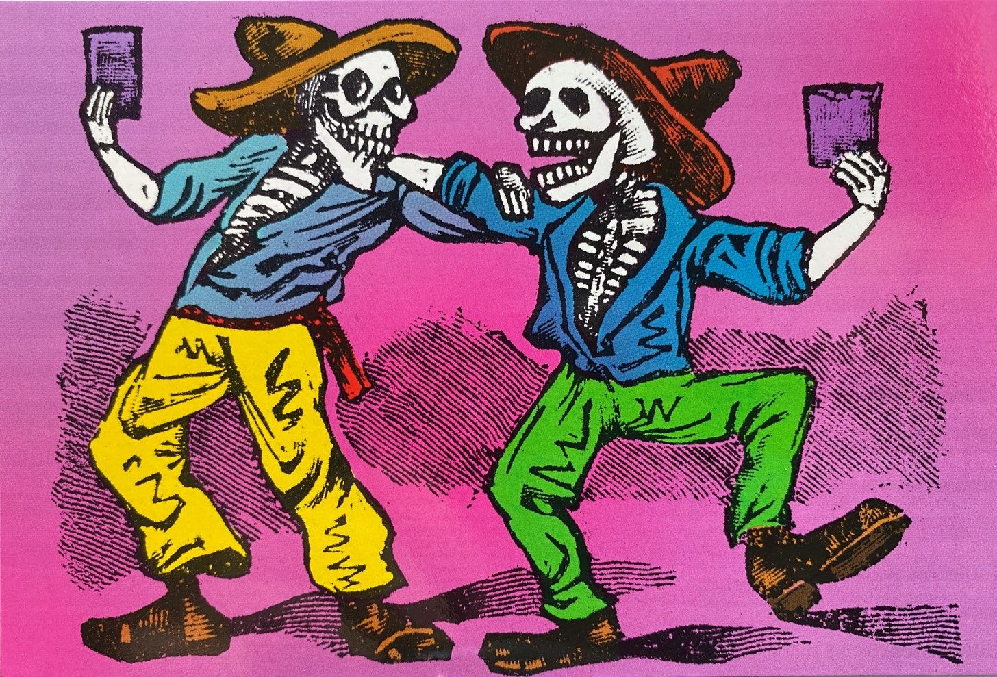 Two skeletons facing each other, both wearing sombreros, long-sleeved button-down shirts, pants and shoes. They are embracing each other with their left and right arm while holding a cup in their free hand.