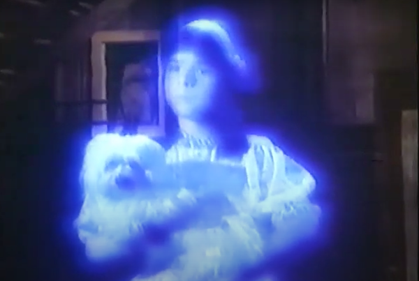 A blue ghost of a young girl and a dog in a still from Child of Glass